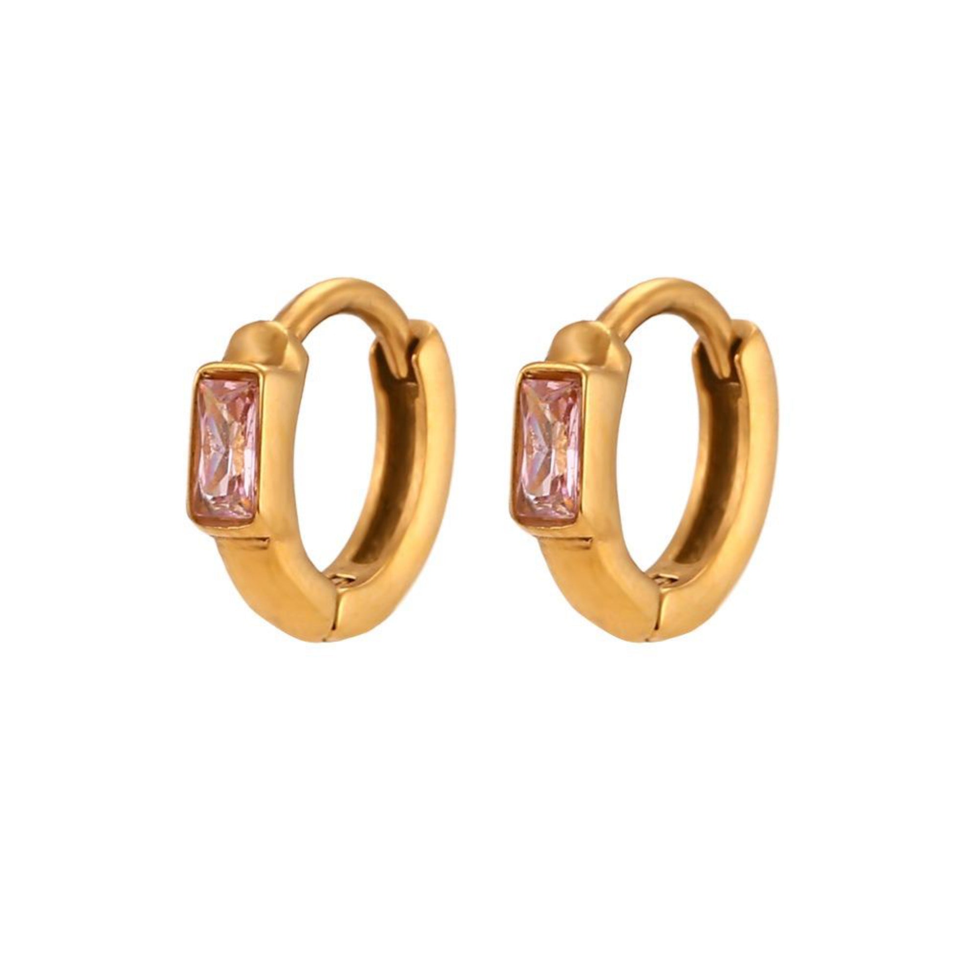 Gold hoop earrings with pink gemstones on a white background